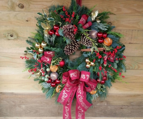 Large christmas door wreath made from evergreen and traditional decoration